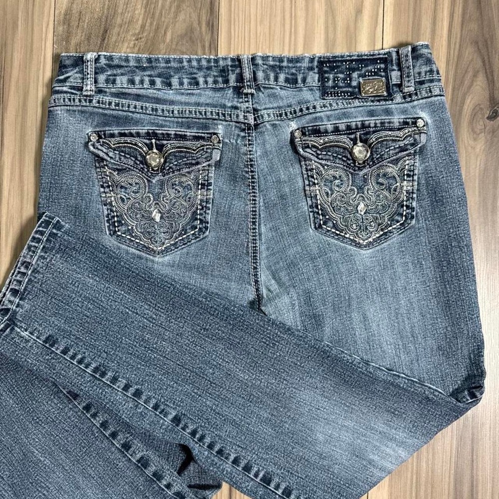 Blue jeans with embroidered floral designs on back pockets